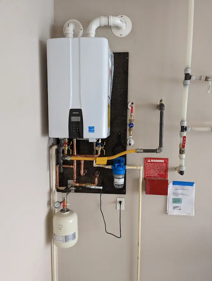 Professional plumber installing copper piping in a Diboll home